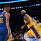 LeBron James #6 of the Los Angeles Lakers reacts after scoring during the second half against Stephen Curry #30 of the Golden State Warriors at Staples Center on October 19, 2021 in Los Angeles, California.